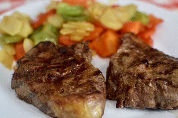 grilled rib-eye steak and stir-fried vegetables